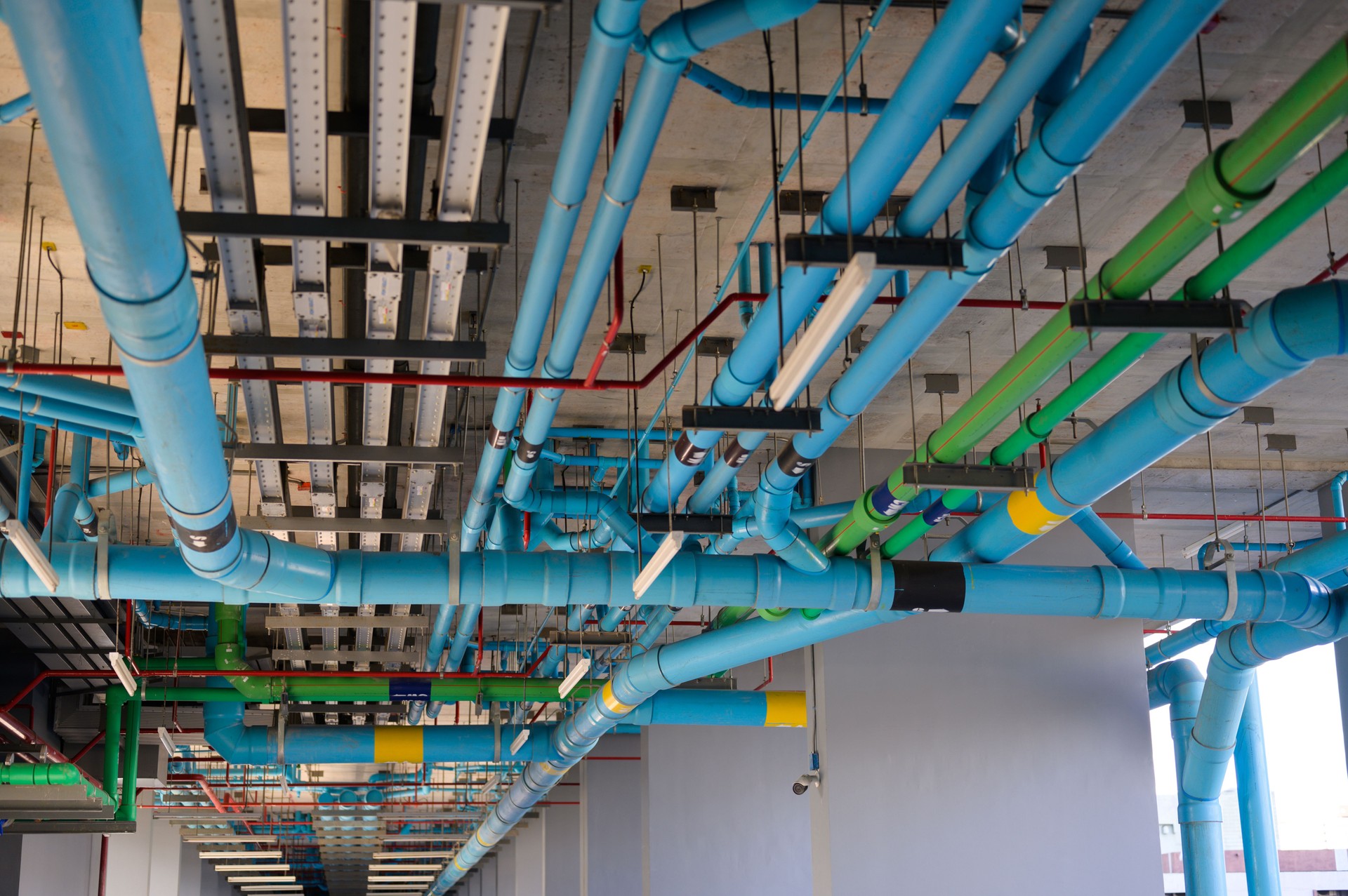 Open system Water mains and drainage under ceiling of building in condominium parking floor  Plumbing piping concept.